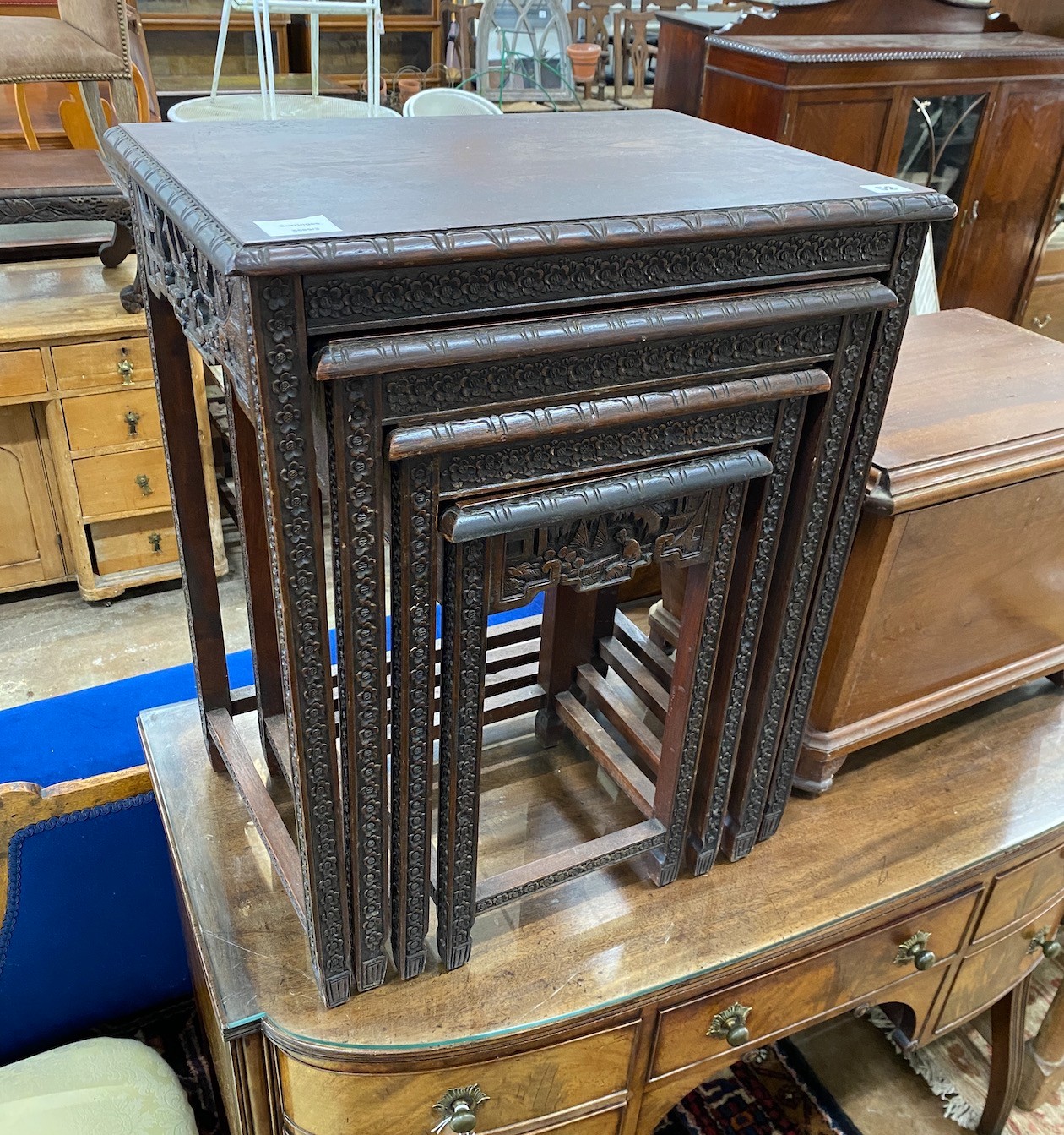 A quartetto of Malaysian rectangular carved hardwood tables, width 52cm, depth 38cm, height 64cm.